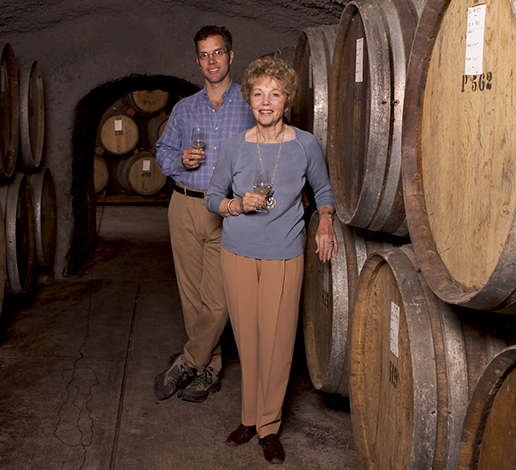 Hugh Davies and his mother, Schramsberg matriarch Jamie Davies, pose in front of wine barrels at the winery in 2005